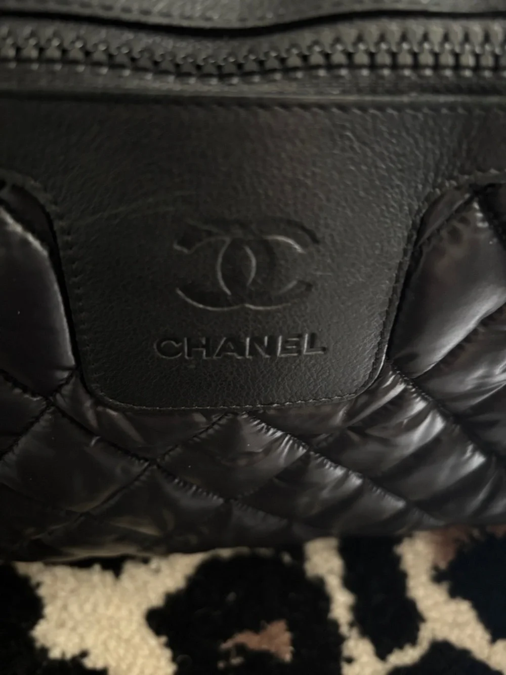 CHANEL Black Quilted Puffer Bag with Embossed CC Patch
